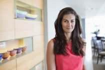 Portrait of confident brunette woman standing at home — Stock Photo