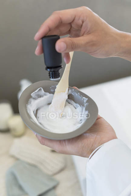 Close-up of female hands preparing hair dye — Stock Photo