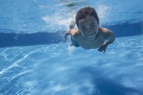 Boy swimming underwater — Stock Photo