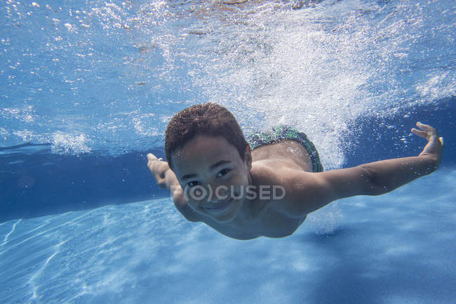 Boy swimming underwater — Stock Photo