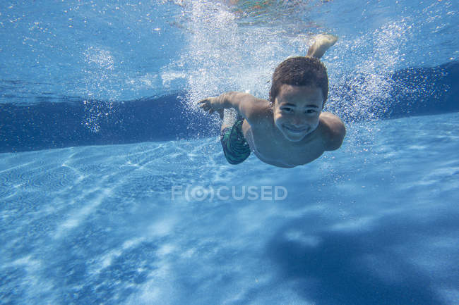 Boy swimming underwater — Stock Photo