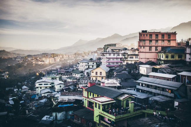 High angle view across a sprawling mountainside village under cloudy sky, Kohima, India — Stock Photo