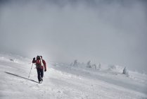 Man hiking in snowy mountains — Stock Photo