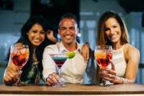 People drinking cocktails and toasting — Stock Photo