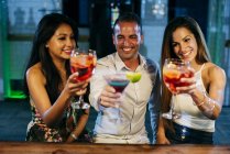 People drinking cocktails and toasting — Stock Photo