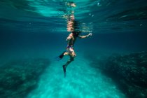 Unrecognizable boy snorkeling in dark sea water — Stock Photo