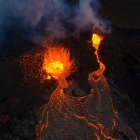 From above magma sparks out of the volcano hole and run like rivers of lava over the ground in Iceland — Stock Photo