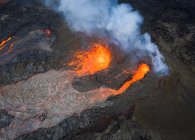 From above magma sparks out of the volcano hole and run like rivers of lava over the ground in Iceland — Stock Photo