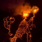 From above magma sparks out of the volcano hole and run like rivers of lava over the ground in Iceland — Stock Photo