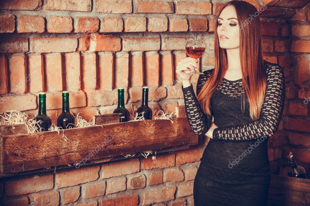 Woman tasting wine in rural cottage interior Stock Photo by ©Voyagerix ...