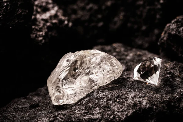 rough diamond and cut diamond in coal mine, mining concept and rare gemstone