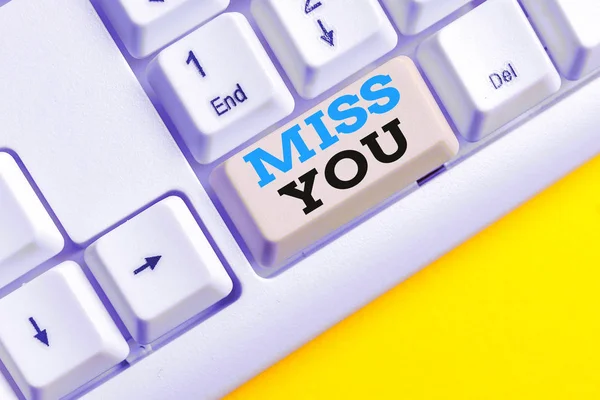 Handwriting text Miss You. Concept meaning Longing for an important demonstrating in your life for a period of time White pc keyboard with empty note paper above white background key copy space.