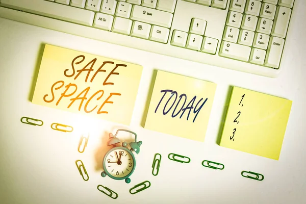 Handwriting text Safe Space. Conceptual photo a place or room in which you are protected from harm or danger Empty orange square papers and clock by the pc keyboard with copy space