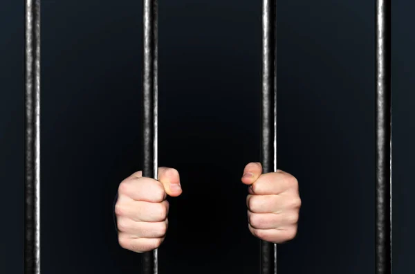 Male hands holding prison bars — Stock Photo © ljsphotography #45888849