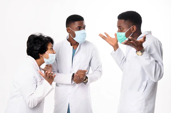 A consultation of doctors who discuss the diagnosis. Doctors on a white background.