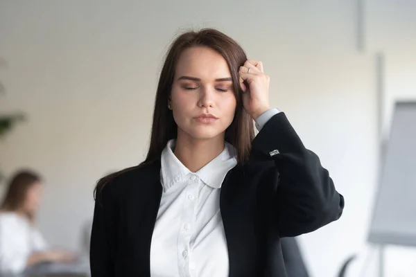 Stressed businesswoman massage head suffering from migraine