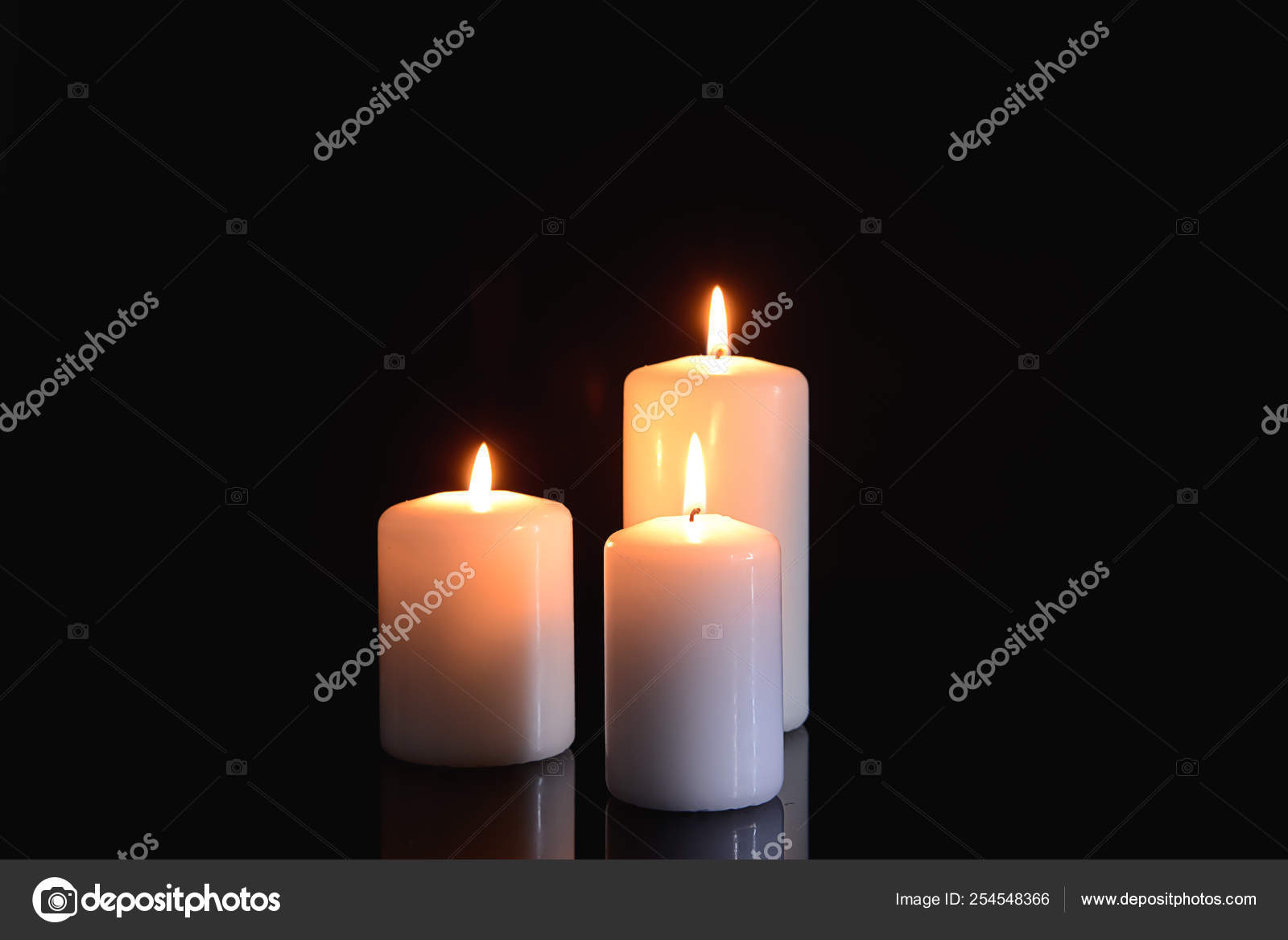 Burning candles on black background Stock Photo by ©serezniy 254548366