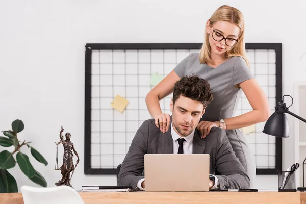 businesswoman making massage to colleague at workplace in office, office romance concept