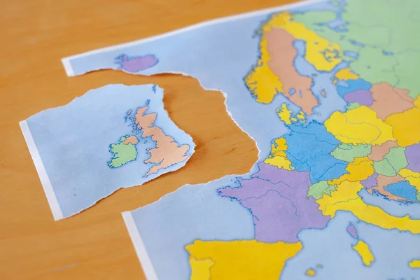 a torn paper map symbolizing the UK leaving the European Union or Brexit