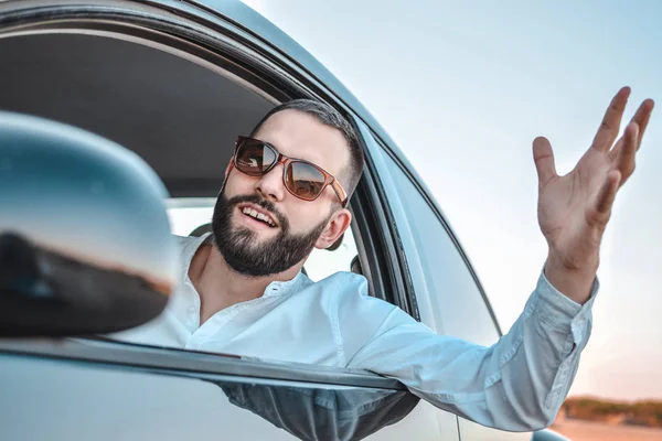 Nervous man sitting at the wheel in his car