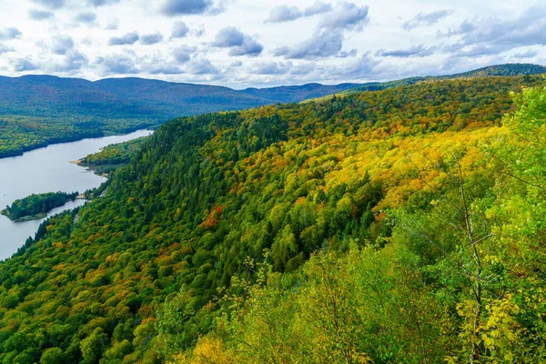 View of La Roche observation point, Monroe Lake and the park, with fall foliage colors in Mont Tremblant National Park, Quebec, Canada