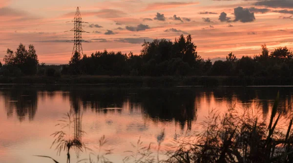 Red-blue sunset reflected in lake symmetricall