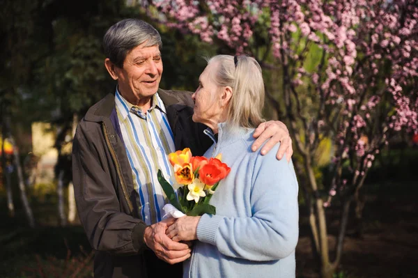 beautiful happy old people sitting in the autumn park