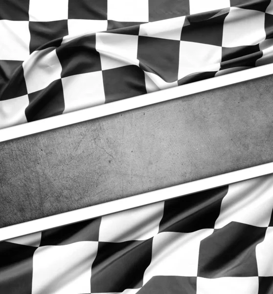 Checkered black and white flag on grey background. Copy space