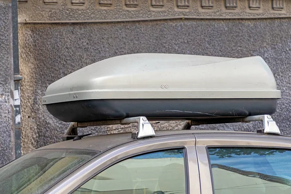 Closed container box on rooftop of the car used for storing items inside