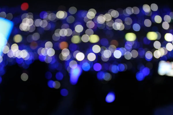 Bokeh effect of light sticks in the concert.  Blue light and blue tone.