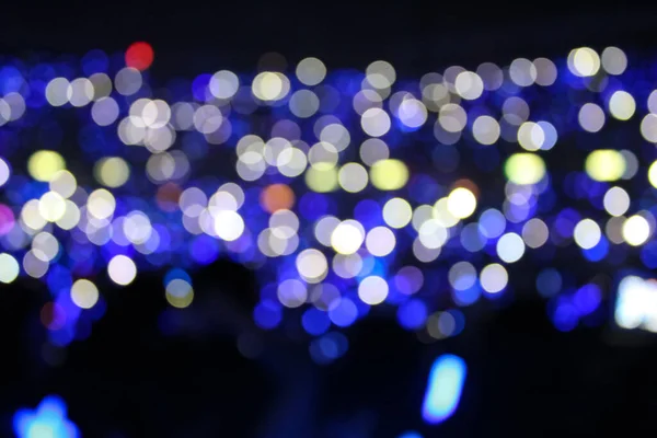 Bokeh effect of light sticks in the concert.  Blue light and blue tone.