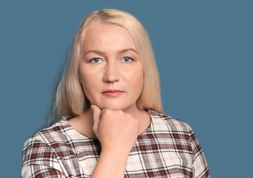 Photo of Portrait of beautiful mature woman on color background