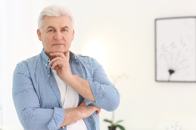 Photo of Portrait of stylish mature man indoors