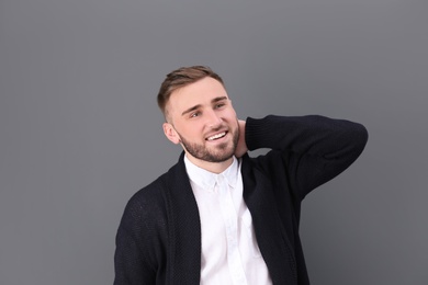 Photo of Portrait of smiling young man on color background