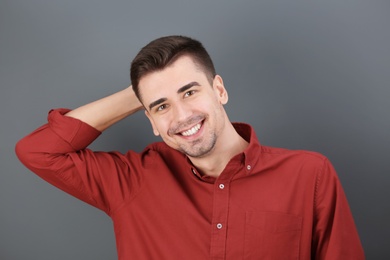 Photo of Charming young man on grey background