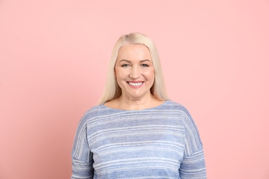 Photo of Portrait of mature woman on color background