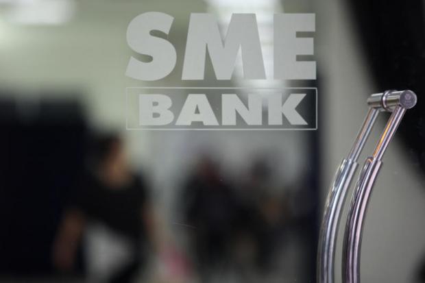 The SME Bank logo at its headquarters on Phahon Yothin Road. The state bank is set to offer low-interest factoring financing for SMEs. WICHAN CHAROENKIATPAKUL