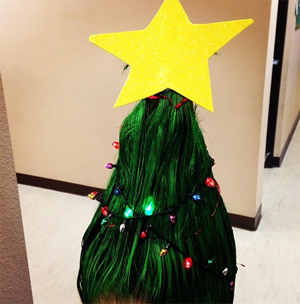 Crazy Hair Day hairstyle resembling a Christmas tree with green hair, adorned with lights and topped with a yellow star.