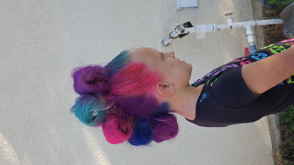 Colorful crazy hair day hairstyle with vibrant blue, pink, and purple curls styled creatively.