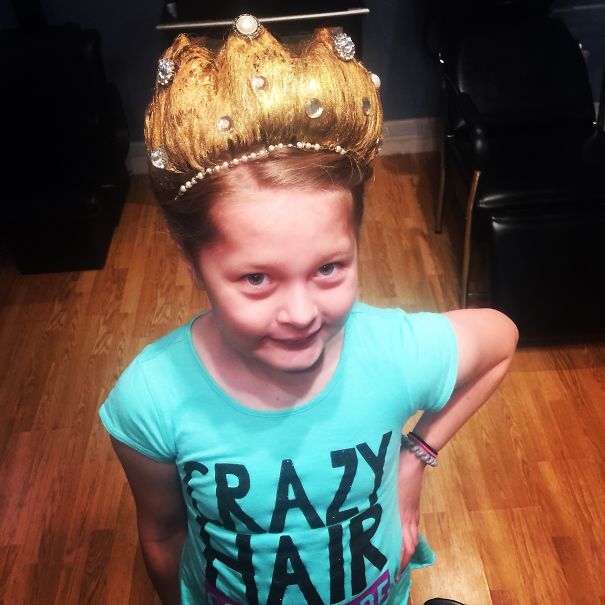 Child with a crown hairstyle for Crazy Hair Day, wearing a turquoise shirt.