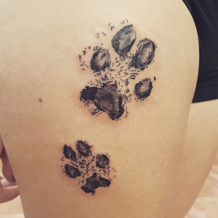 Dog paw print tattoos on skin, showcasing detailed design and creativity.