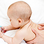 baby tummy time being massaged