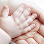 babies hand on adults