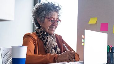 Woman working at a desk.