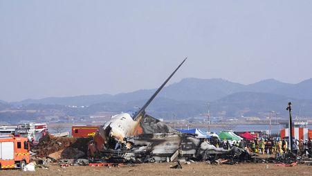 Firefighters work near the wreckage of the Jeju Air plane that ran off the runway of Muan International Airport in South Korea, 29 December, 2024