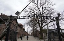 People visit the Memorial and Museum Auschwitz-Birkenau, a former Nazi German concentration and extermination camp, in Oswiecim, Poland, Sunday, Jan. 26, 2025.