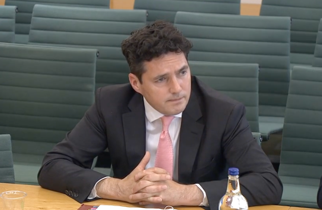 <p>Huw Merriman, the former rail minister, appearing at the transport select committee</p>