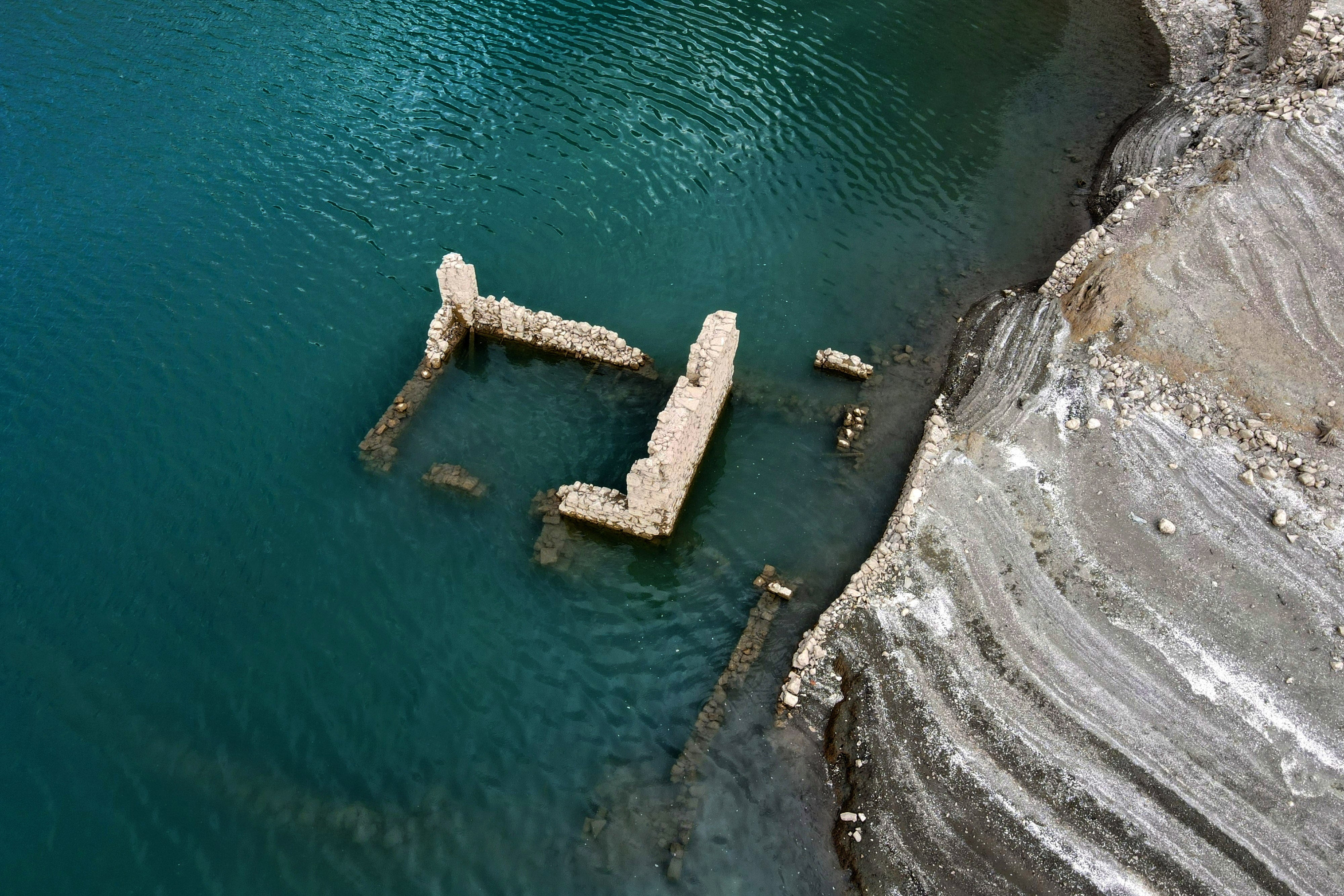 The remains of a building of the sunken village of Kallio is revealed due to the receding water level of Mornos artificial lake, near the village of Lidoriki