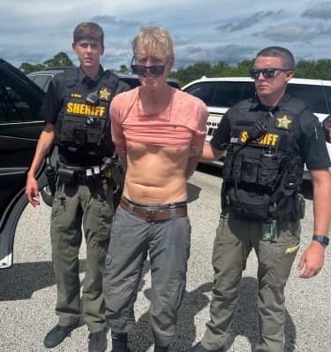 Ryan Routh is seen being taken into custody on the I-95 on Sunday