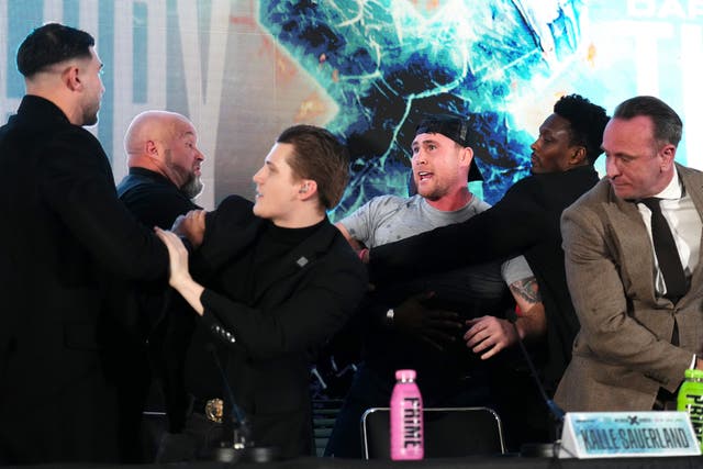 <p>Tempers flared between Tommy Fury (left) and Darren Till (centre) during their press conference last month </p>